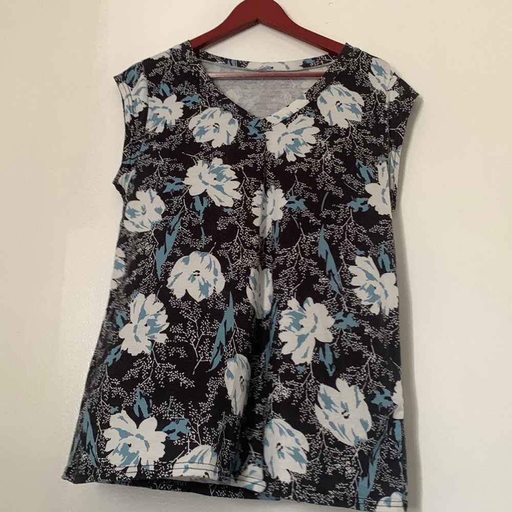 Sleeveless black, white, and light blue blouse